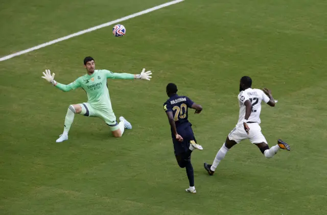 Kolo Muani dinks the ball over Courtois
