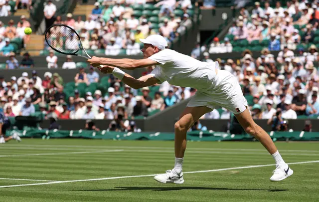 Jannik Sinner hits a backhand at Wimbleon