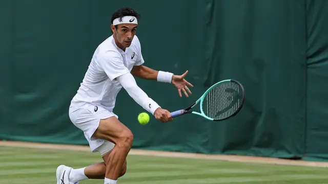 Lorenzo Musetti plays a backhand return