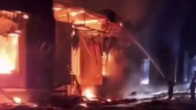 A fire is seen being put out after an apparent strike