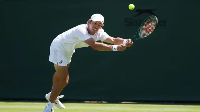 Alex de Minaur of Australia plays a backhand