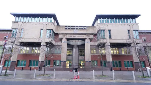 Four-story modern building with a large central entrance - among pillars on the front, the words The Law Courts are written