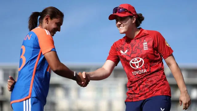 Nat Sciver-Brunt of England shakes hands with Harmanpreet Kaur of India