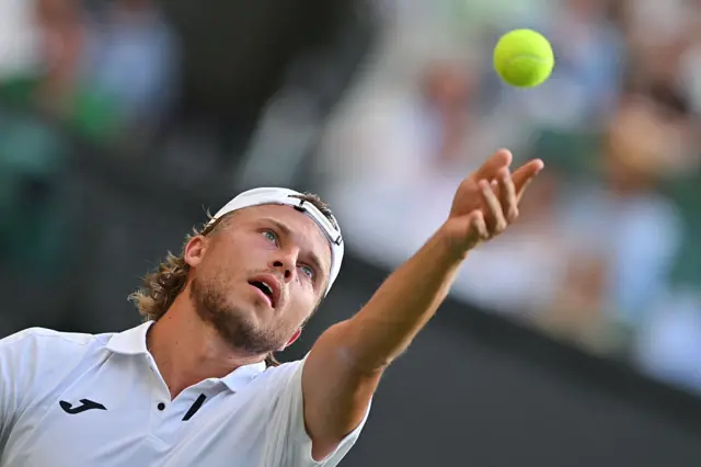 Alexandre Muller serves at Wimbledon