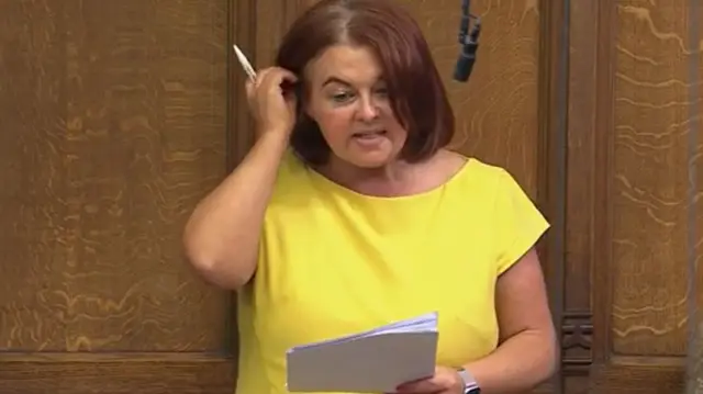 Paula Barker in yellow dress in the Commons