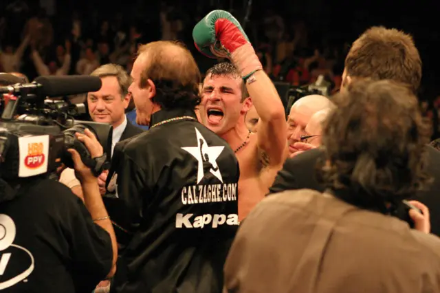 Joe Calzaghe with his arm in the air celebrating