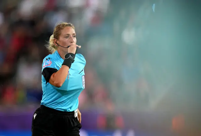 Referee Alina Pesu looks on