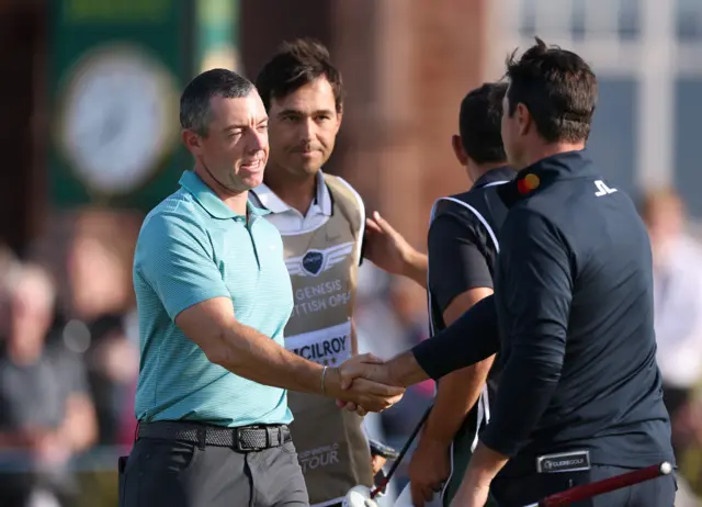 McIlroy sports a new trim while shaking hands with Viktor Hovland