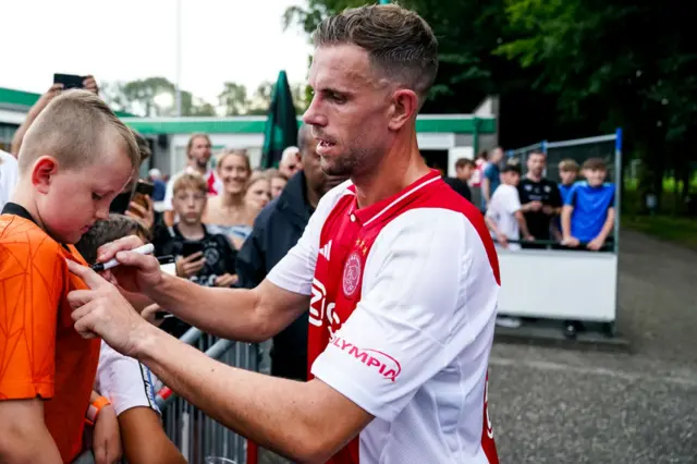 Jordan Henderson with an Ajax fan