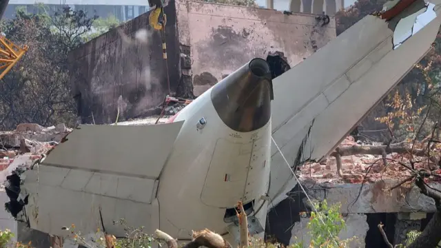 Damaged section of a plane in rubble following a crash