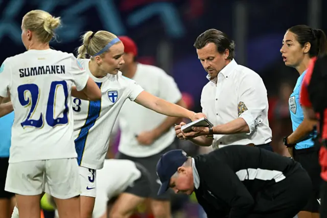 Eva Nystrom listens to Finland's coach Marko Saloranta