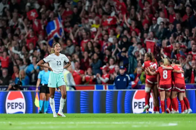 Iceland players stand disappointed after Switzerland's goal