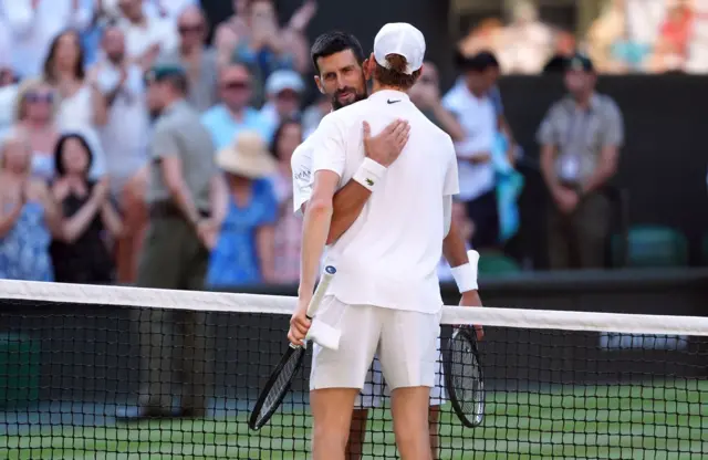 Novak Djokovic embraces Jannik Sinner