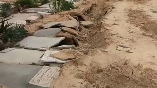 A screengrab from a verified video we can see cracked headstones in the cemetery