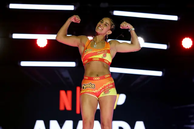 Amanda Serrano posing by flexing her biceps