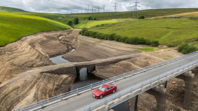 Dry earth can be seen on the banks of Baitings Reservoir in Ripponden, West Yorkshire