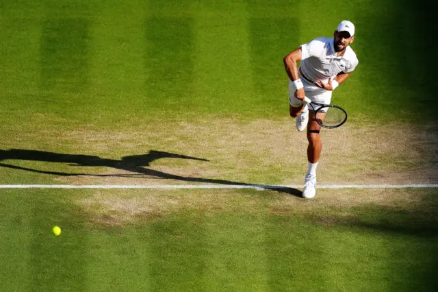 Novak Djokovic serves