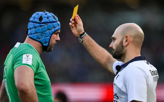 Andrea Piardi gives Tadhg Beirne a yellow card