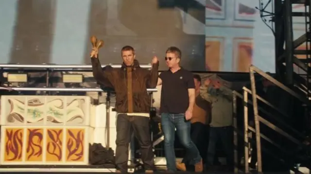 Liam and Noel Gallagher on stage at Heaton Park