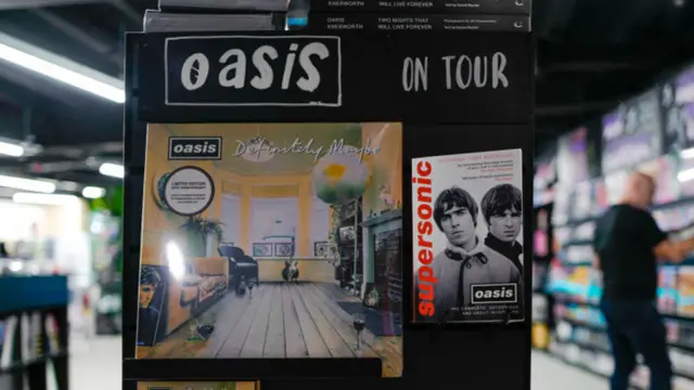 A shop display featuring the Oasis album Definitely Maybe and the book Supersonic
