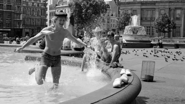 A person in the fountains at Trafalgar Square
