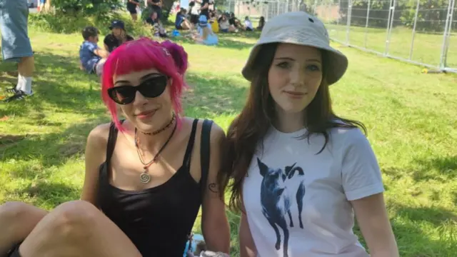 May and Stella sitting on the grass.