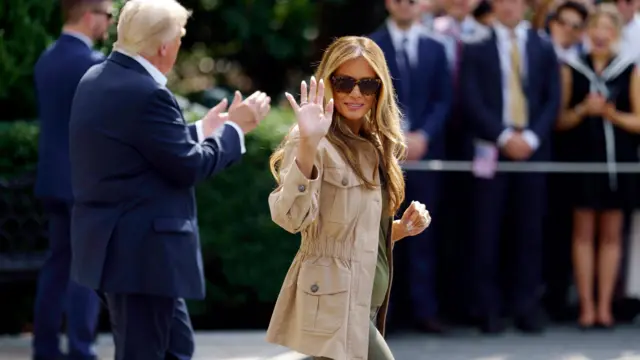 US First Lady Melania Trump (R) waves to the media before leaving the White House on board Marine One,