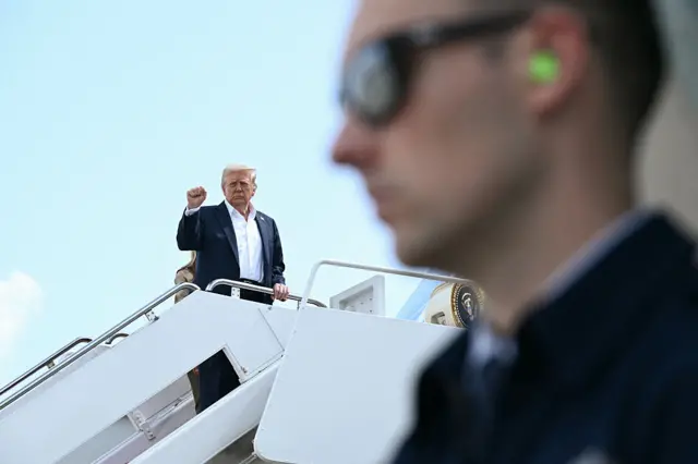 US President Donald Trump gestures as he boards Air Force One at Joint Base Andrews, Maryland