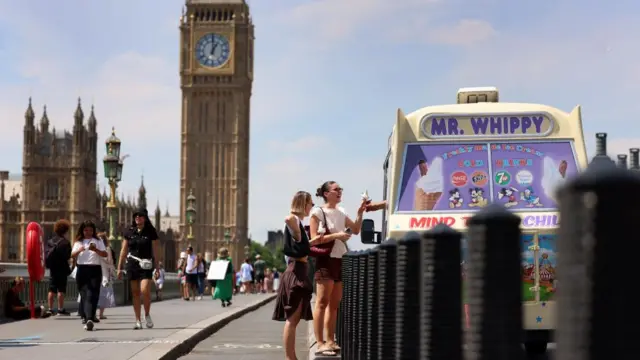 a  woman purchases an ice-cream on Westminster Bridge in London