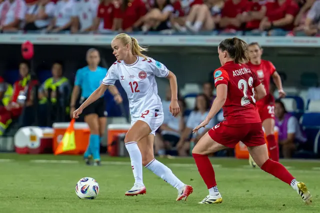 Kathrine Moller Kuhl of Denmark (L) runs with the ball under pressure from Adriana Achcinska of Poland (R)