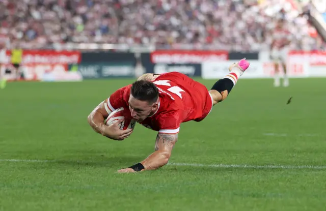 Wales' Josh Adams scores a try