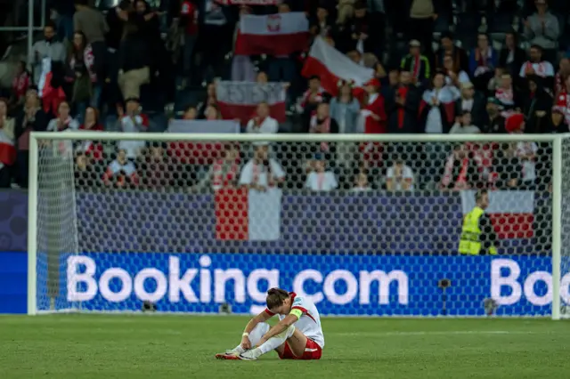 Ewa Pajor sits on the turf at full time after the Sweden defeat