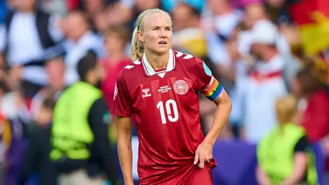 Denmark skipper Pernille Harder comforts a teammate at full time