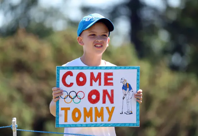 A young fan holds up a 'come on Tommy' sign