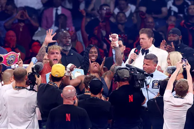 Green celebrates in the ring as she is announced the winner