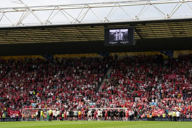 Liverpool players and staff applaud the fans as the big screen shows a tribute in memory of Liverpool player Diogo Jota following the pre-season friendly match at Deepdale Stadium, Preston. Liverpool remain in mourning following the death of Portugal forward Jota, 28, and his brother Andre Silva, 25, in a car crash in Zamora, Spain, on July 3