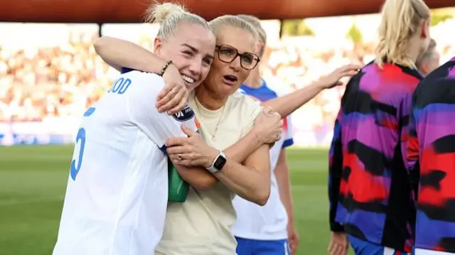 Sarina Wiegman, Head Coach of England, and Alex Greenwood of England embrace at full-time