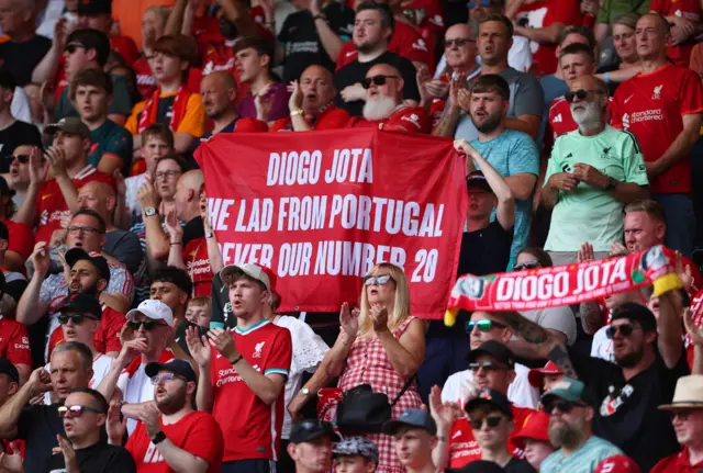 Liverpool fans display banners in the stands in tribute to Liverpool's Diogo Jota during the match