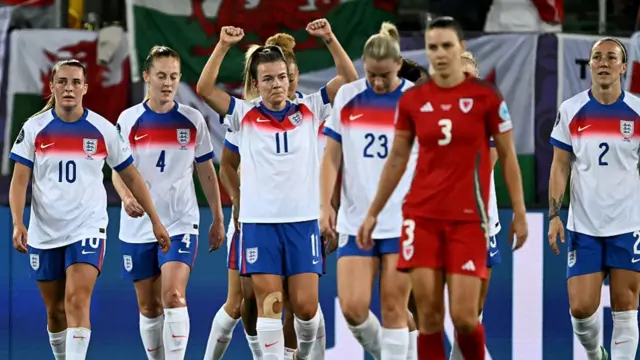 England's forward #11 Lauren Hemp celebrate with teammates after scoring the third goal of the match