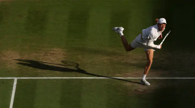 Jannik Sinner serves