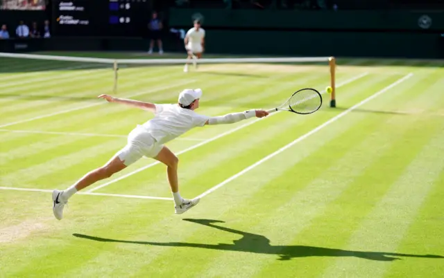 Jannik Sinner returns serve