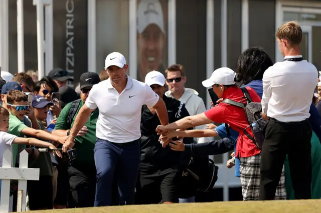 Rory McIlroy walks through the crowd to the teebox
