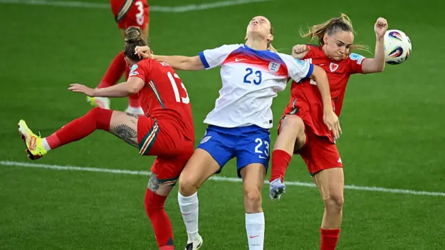 Alessia Russo of England competes for the ball with Rachel Rowe and Lily Woodham of Wales