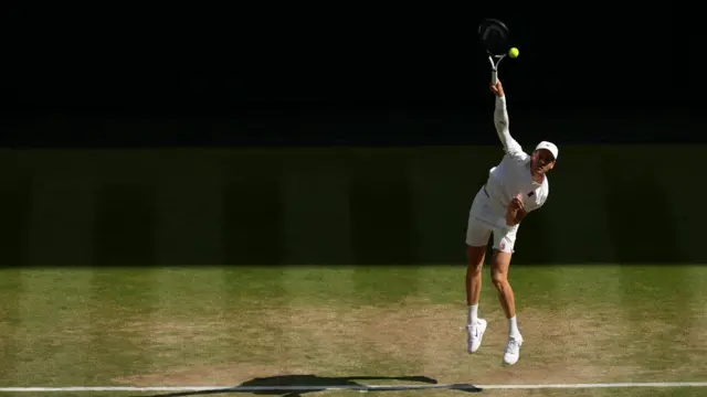 Jannik Sinner serves
