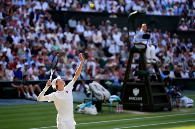 Jannik Sinner serves