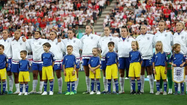 The players of England sing their national anthem