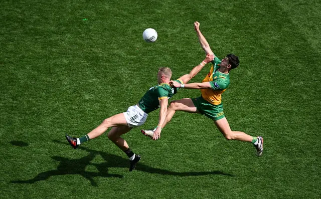 Michael Langan challenges for the ball