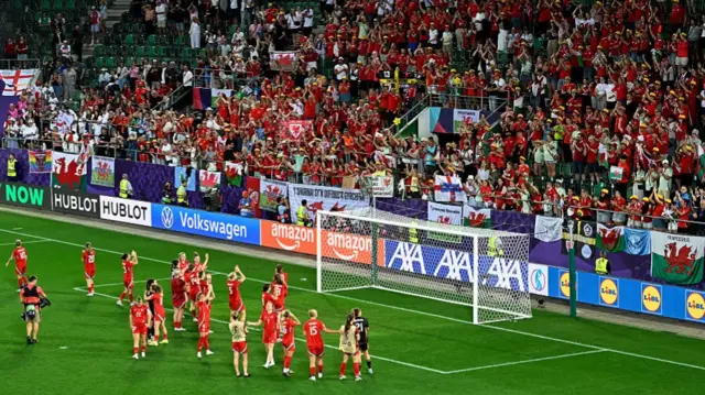 Wales players applaud their fans
