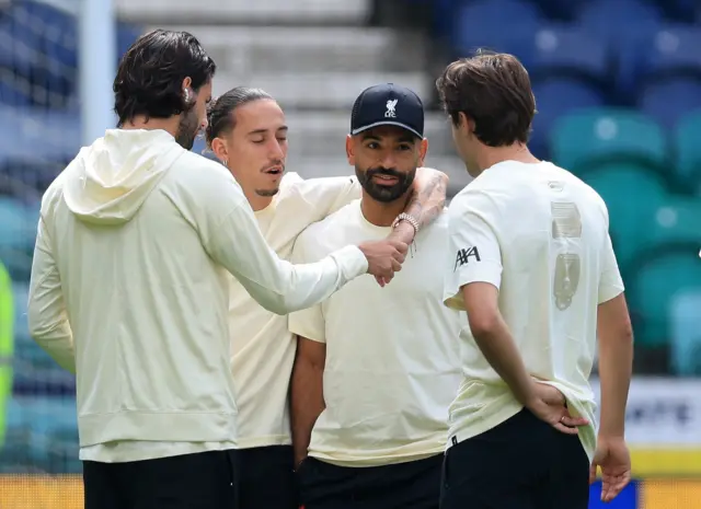 Kostas Tsimikas of Liverpool puts his arm around Mohamed Salah as the players walk on the pitch ahead of the pre-season friendly match between Preston North End and Liverpool