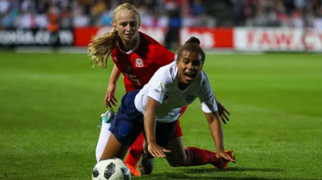 Nikita Parris of England Women is tackled by Elise Hughes of Wales Women during 2019 FIFA Women's World Cup Group 1 qualifier between Wales Women and England Women at Rodney Parade stadium,